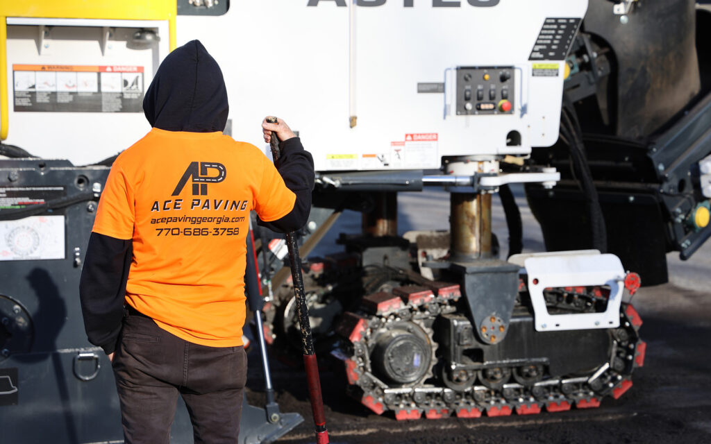 Worker in a hoodie wearing ace paving t-shirt